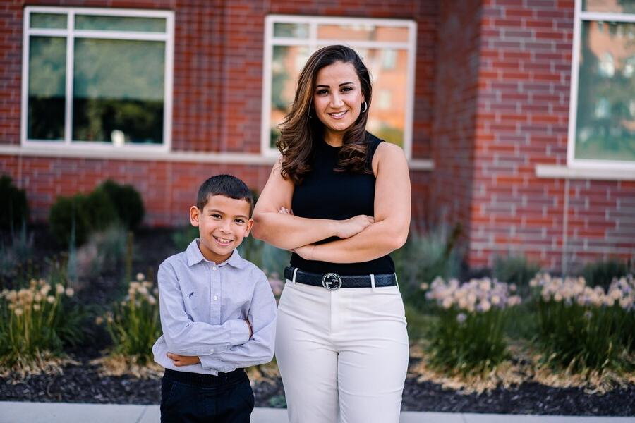 Rae Sallae and her son standing in front of Acklie Hall.